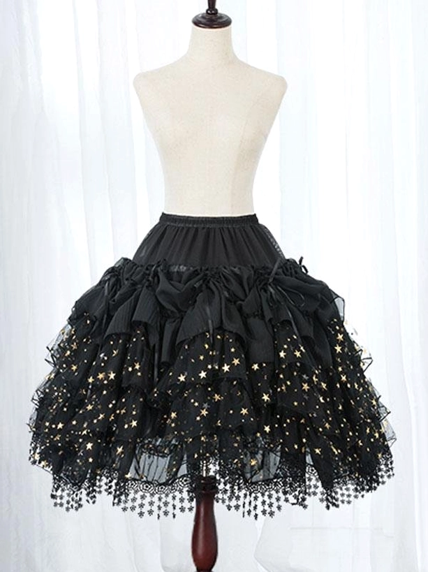 Close-up detail of black Lolita petticoat displaying gold star printed mesh, decorative ruffled bows, and handcrafted tassel lace hem