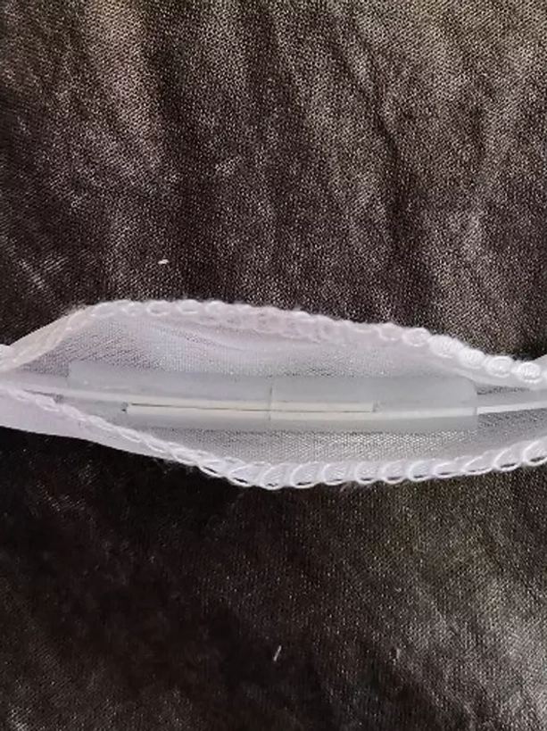 Lolita petticoat waistband close-up detail showing white elastic band with lace trim and plastic buckle adjustment mechanism