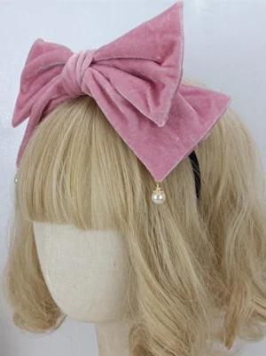 Lolita headwear blush pink velvet bow with pearl charm on black elastic headband, front view styling with bangs wig for sweet lolita coordinates