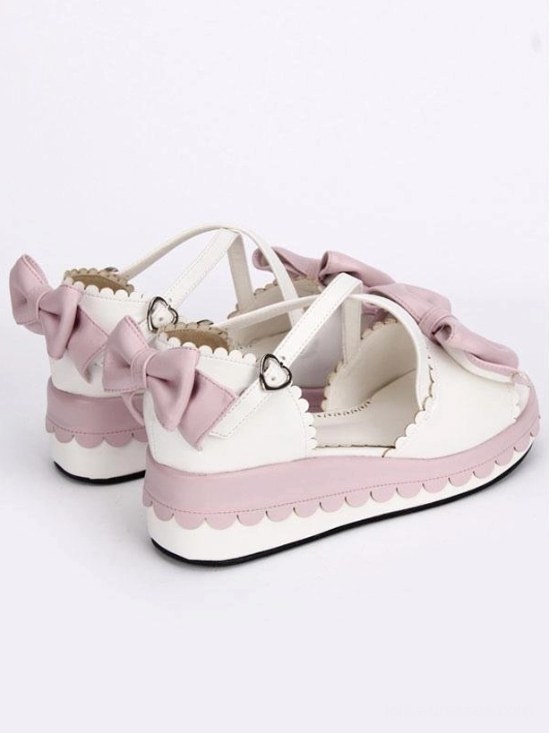 Pair of sweet lolita platform sandals rear three-quarter view displaying back heel bows and cross ankle straps design on white background