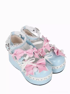 Lolita platform shoes top view showing pink satin bows pom-pom details and heart-shaped ankle buckle