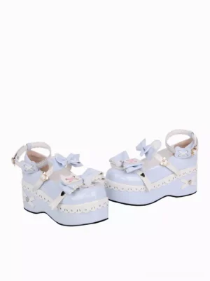 Side profile of pastel blue lolita wedge heel shoes featuring light blue patent leather, decorative vamp bows, heart-shaped ankle buckle, and elegant platform silhouette