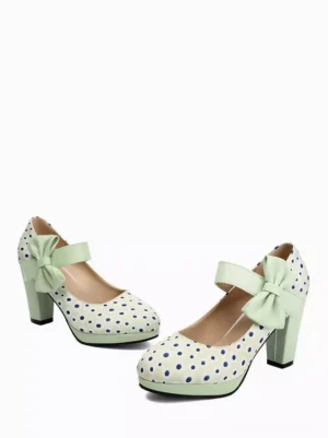 Mint green polka dot Mary Jane lolita shoes flat lay display with bow strap and chunky heel white background