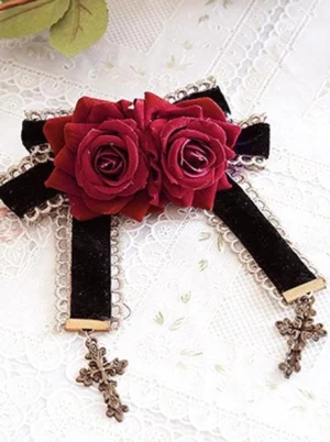 Matching lolita rose bow brooch with dark bronze cross embellishments, burgundy roses, and scalloped lace edging detail shot