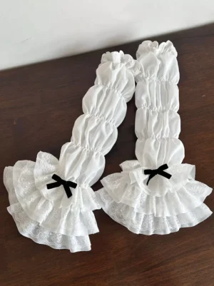 Lolita ruffled arm sleeves pure white with black velvet bow tiered lace trim overhead shot