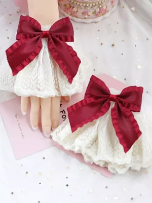 Elegant wine red satin bow Lolita oversleeves with layered ruffled off-white lace, sweet fashion aesthetic flat lay presentation