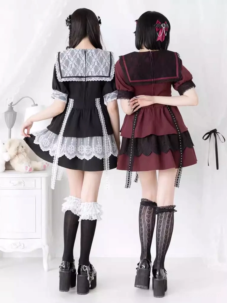 Rear view of two model wearing black and wine red lolita dresses showing back design with lace sailor collar and tiered ruffle hem with tassels