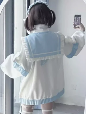 Back view of sailor collar Lolita coat showing ruffled back sailor collar detail blue hem trim and oversized loose fit silhouette mirror selfie perspective