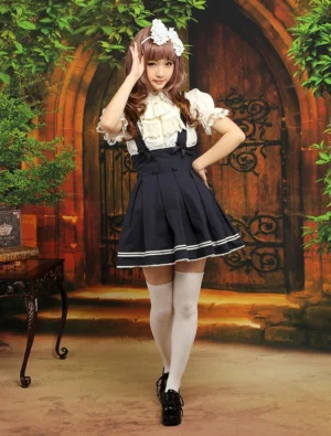 Dark navy Lolita salopette skirt featuring white stripe hem trim, standing front pose with white thigh-high socks on garden backdrop