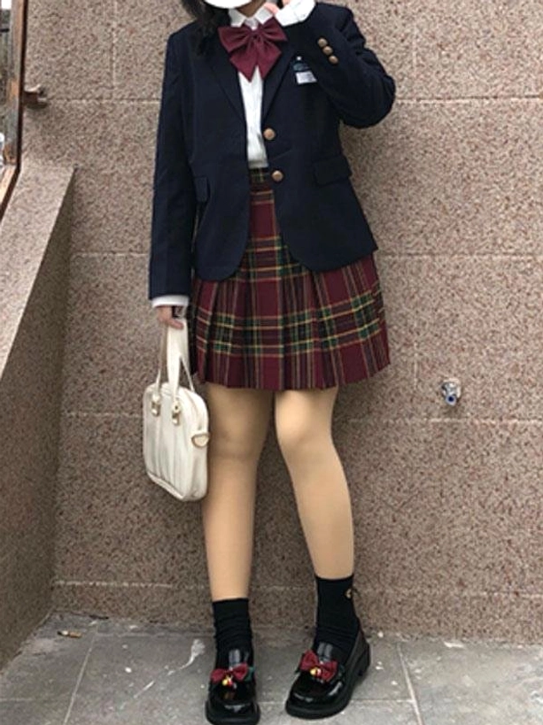 Black lolita school pumps full lower standing view worn with jk school uniform and black ankle socks matching shoe decoration bell charm