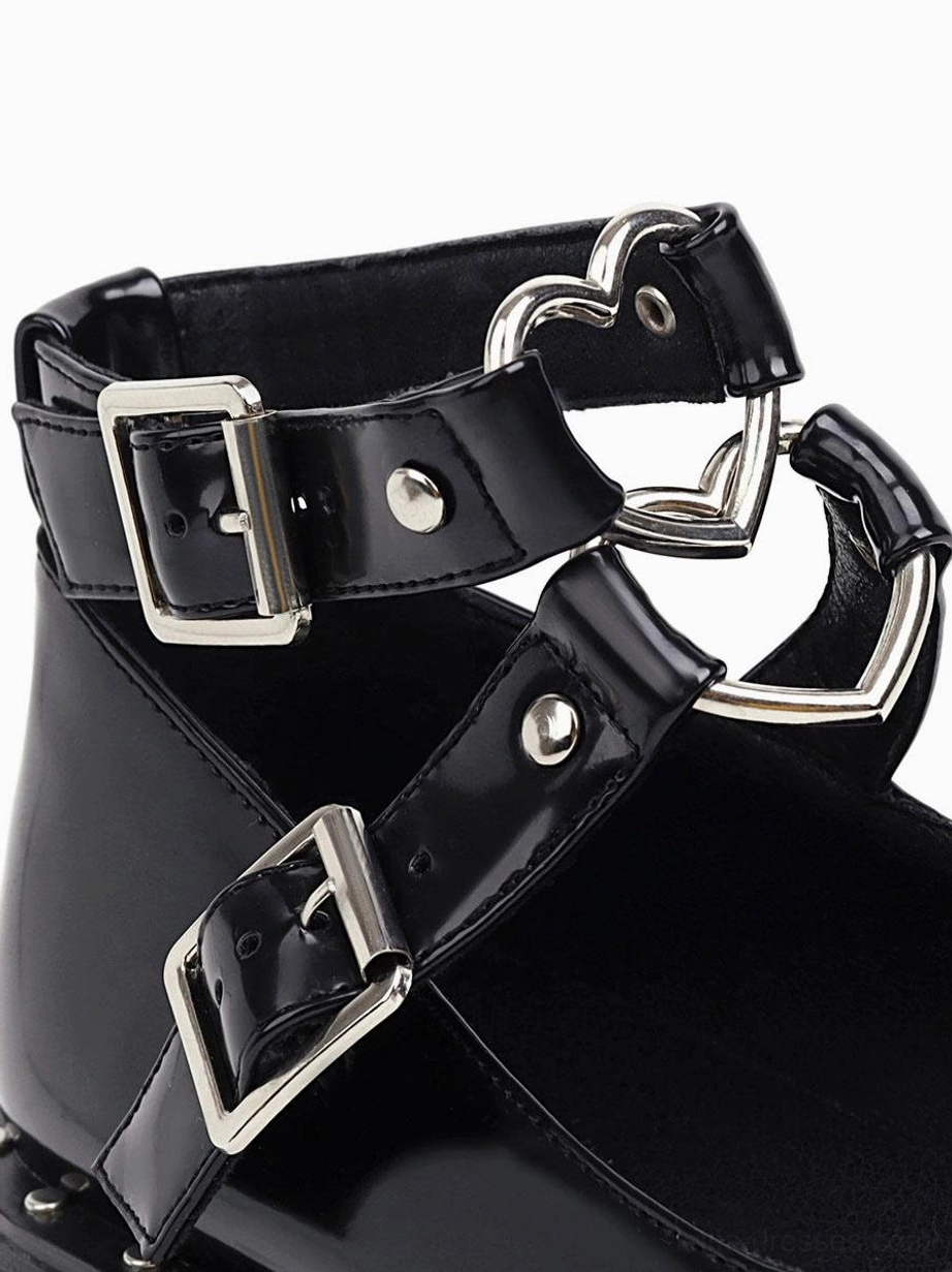 Close-up detail of black lolita shoes hardware heart-shaped metal buckle fasteners silver accents glossy pu leather
