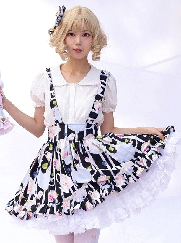 Lolita suspender skirt front low angle view emphasizing wide suspender straps and full white lace hem, model wearing complete outfit