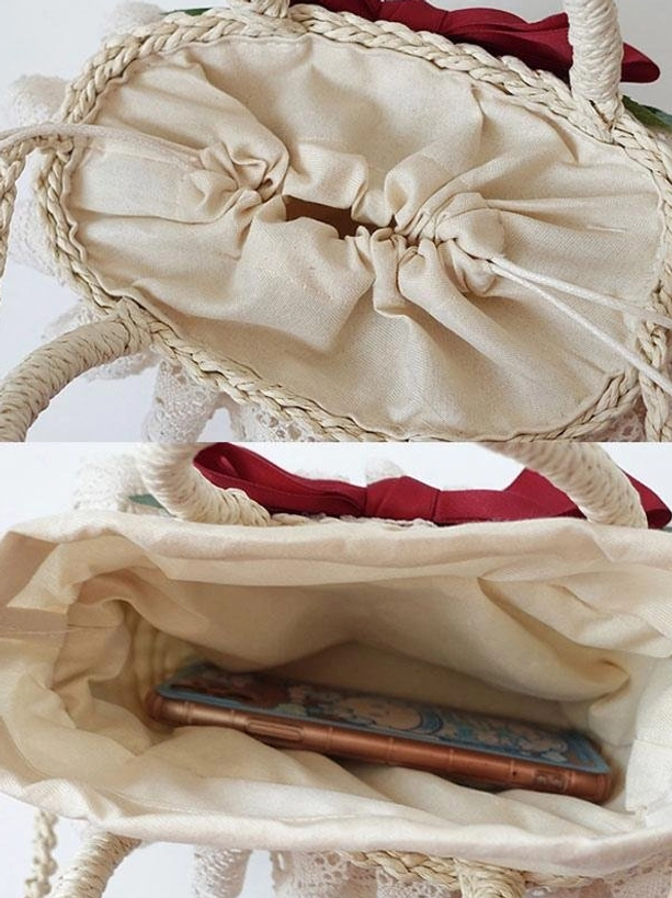 Interior top structure of lolita straw handbag showing drawstring linen lining, woven straw trim detail, and red decorative top bow closure, close-up overhead view