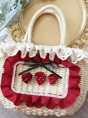 Lolita straw handbag with lace ruffle trim and strawberry bow charm, beige woven exterior with wine red ruffled frame, vintage gold plate styling