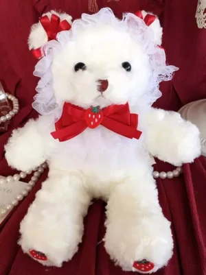 Lolita plush bear crossbody bag flat lay frontal view, white fluffy material with red velvet bows, delicate white lace collar, red strawberry chest bow, red ear decorations, kawaii aesthetic