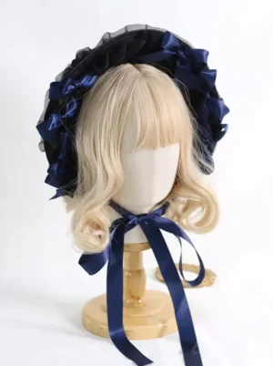 Victorian Lolita headpiece flat lay displaying navy blue satin bow details and black mesh construction