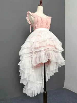 Pink Lolita coordinate featuring white detachable tiered train skirt with matching frilled top, rear three-quarter view displaying multi-layered ruffles