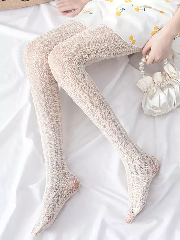 Flat lay product display of lolita fishnet tights in black and beige colorways for coordinate styling reference