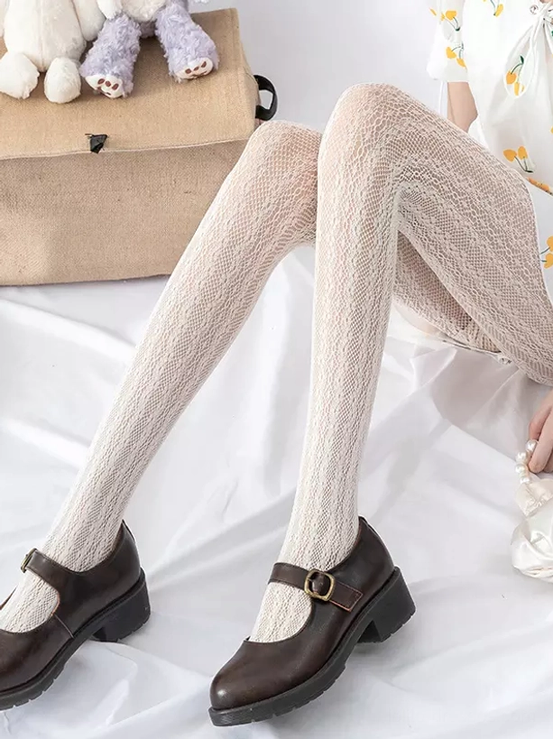 Close-up detail of lolita mesh tights texture showing intricate lace pattern and craftsmanship