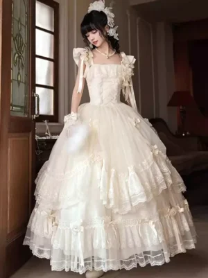 Elegant fairy tale Lolita wedding dress featuring fitted corset bodice and voluminous tiered tulle skirt, front standing pose with floral hair ornament in vintage indoor setting