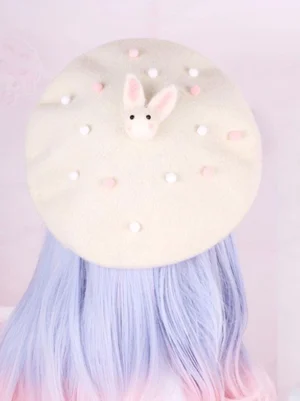 Cream white Lolita beret headpiece with felt rabbit and pink pompom trim overhead flat lay view