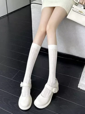 Sweet lolita white hollow knit socks side angle seated girl white mini dress matching handbag Mary Jane shoes studio photography