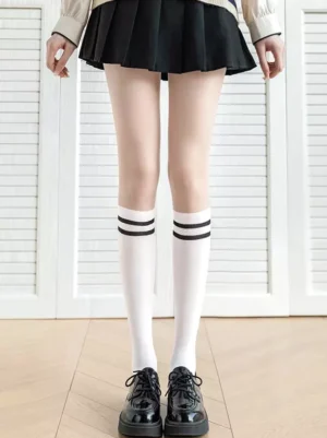 Classic lolita white knee-high socks with black horizontal stripes full lower body front view with black pleated skirt