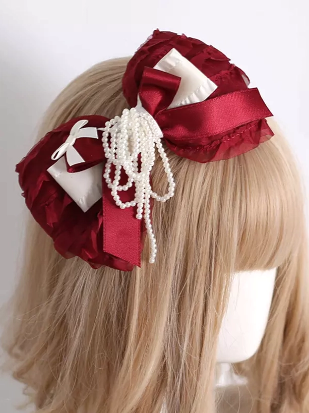 Lolita wine red bow headdress side profile view on mannequin with long light brown wig showing left side pearl tassel decoration