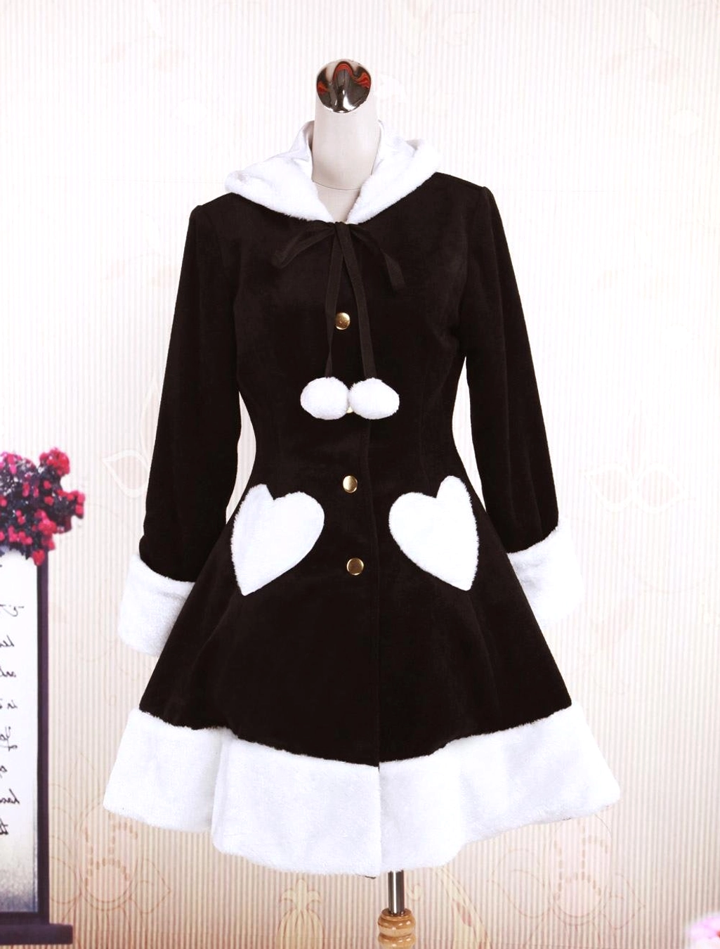 Mannequin display of sweet lolita overcoat front view featuring fuzzy hooded collar, golden front buttons, and structured silhouette