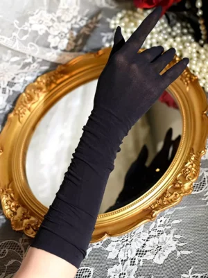 Long black sheer lace evening gloves with ruched cuffs closeup side view vintage gold mirror backdrop lolita fashion accessory