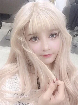 Pale blonde sweet Lolita synthetic wig with blunt fringe, neutral front angle displaying full length wavy curly hair, loose flowing blonde strands and precision bangs detail
