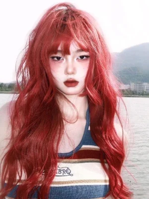 Sweet lolita wig in vibrant orange-red color - medium frontal shot showcasing voluminous loose waves and neat blunt-cut bangs for harajuku fashion styling