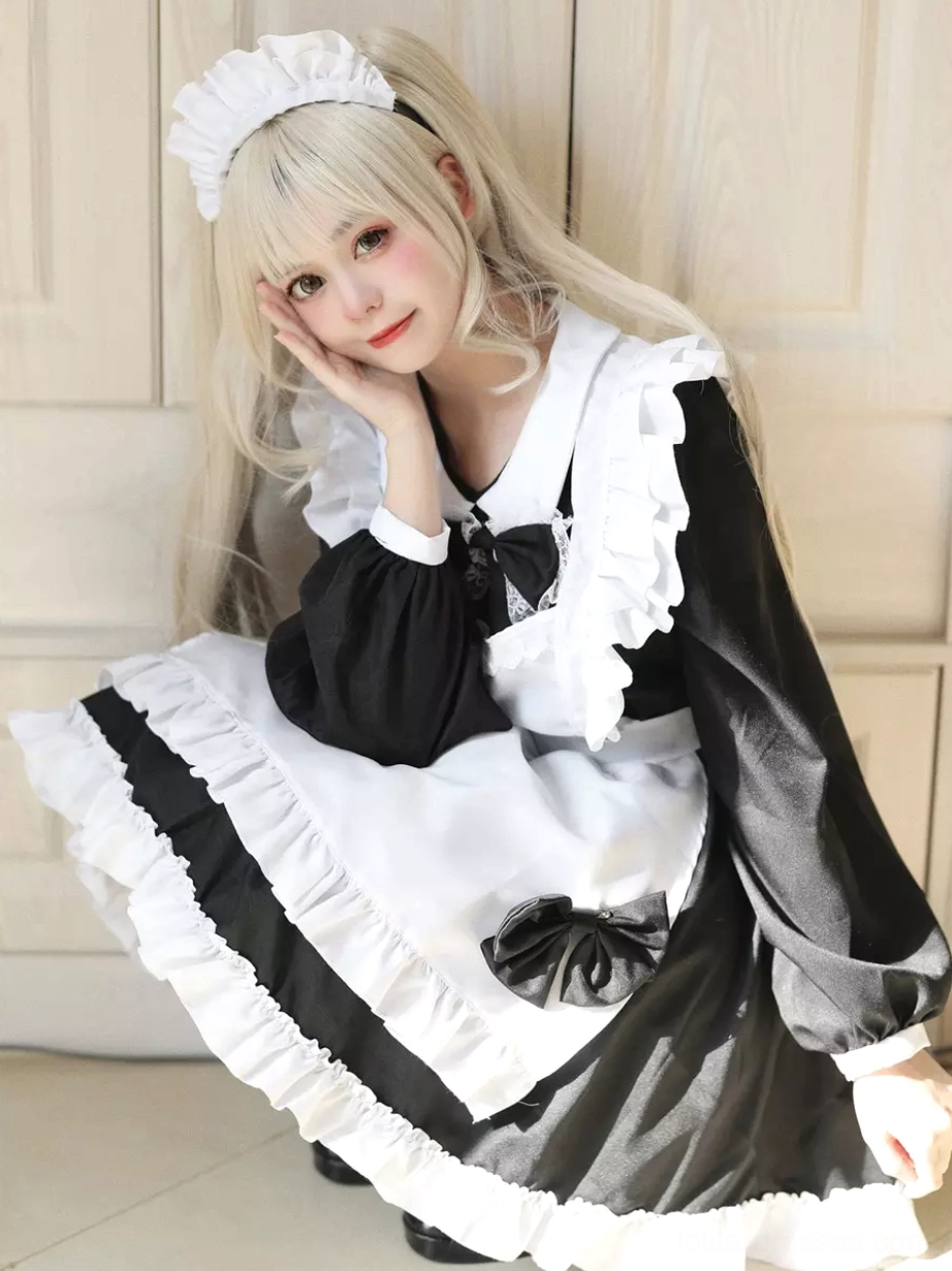 Maid lolita dress apron detail showing layered ruffles and bow placement ruffled hem