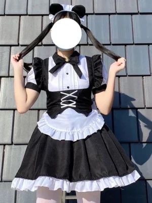 Black and white maid lolita dress front flat lay view featuring ruffled skirt hem, lace-up bandage waist design, puff short sleeves, and bow necktie on faceless model with cat ear headwear against tile roof background