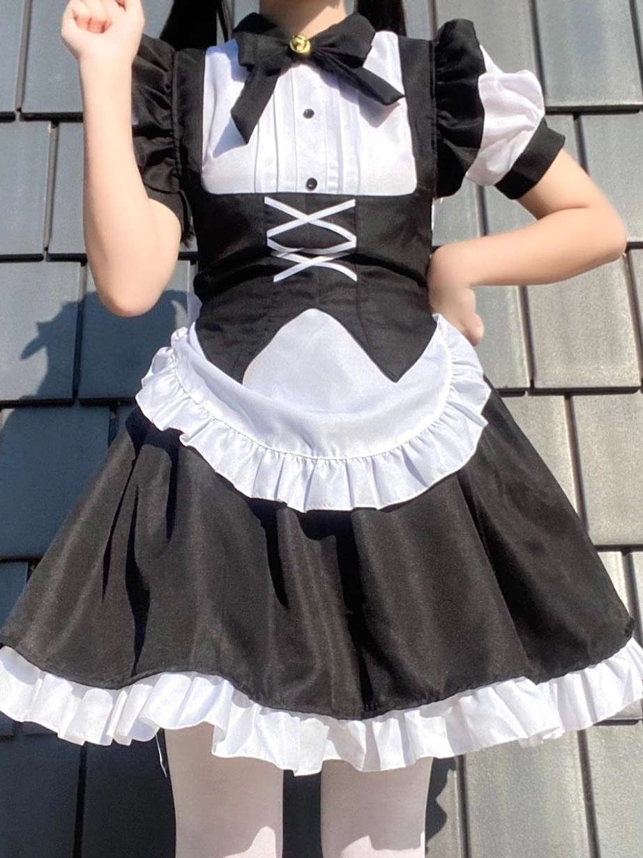 Black and white maid cosplay lolita dress half-body front view on faceless model wearing white stockings, displaying puff short sleeves, bow necktie, and structured silhouette