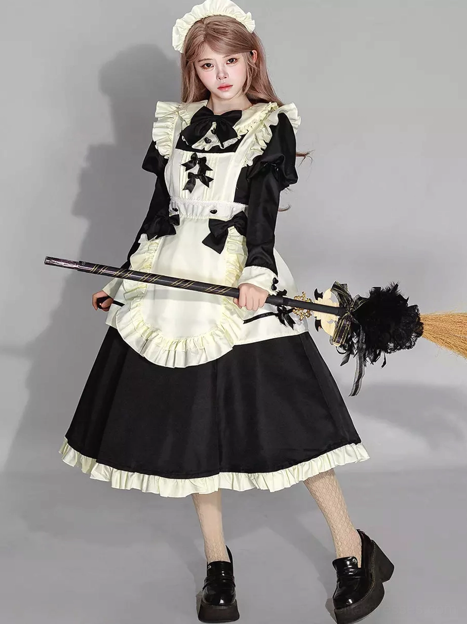 Black and white maid lolita dress front full body view worn by blonde model holding broom prop