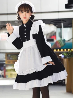 Black sweet lolita maid dress with flutter shoulder ruffles, long sleeve frilled cuffs, and layered ruffled skirt hem detail on model