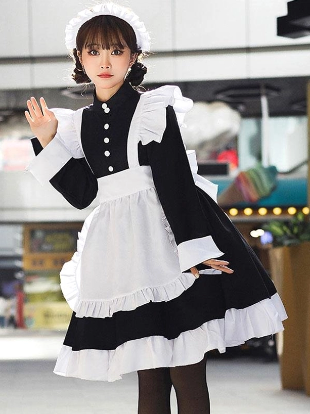 Black sweet lolita maid dress with flutter shoulder ruffles, long sleeve frilled cuffs, and layered ruffled skirt hem detail on model