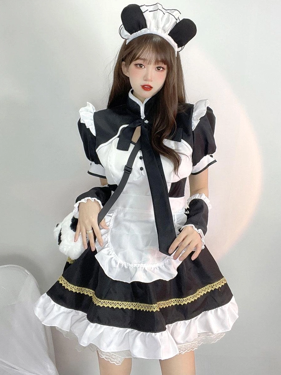 Black and white maid lolita dress with gold woven trim skirt ruffled hem details - side angle view