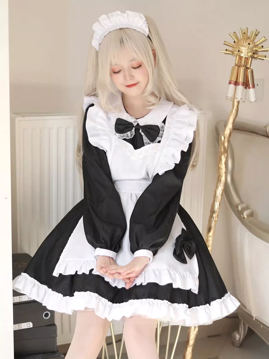 Maid lolita dress detail shot showing ruffled lace trim and bow embellishments close-up view