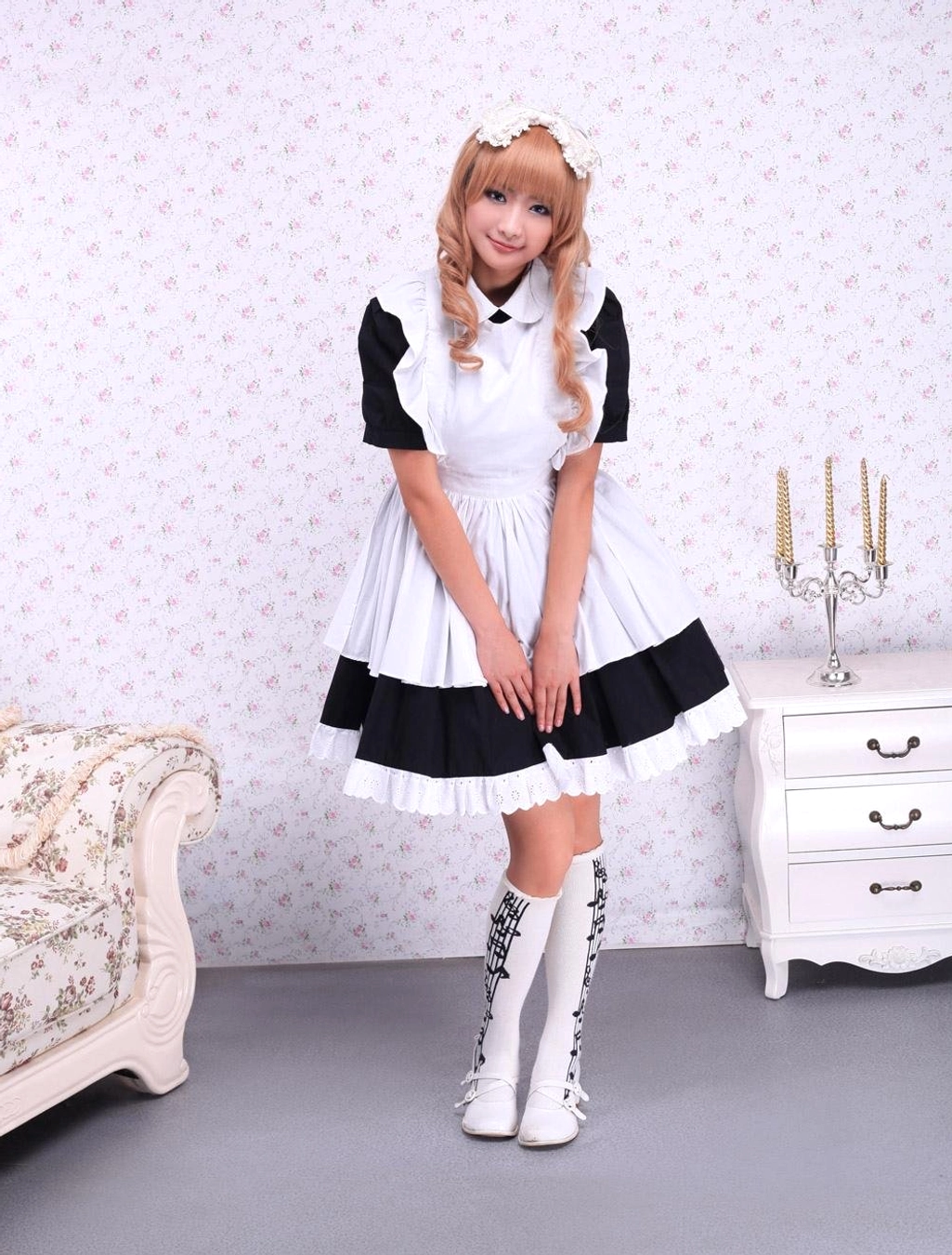 Front view maid lolita OP dress model with hands on ruffled skirt peter pan collar white boots