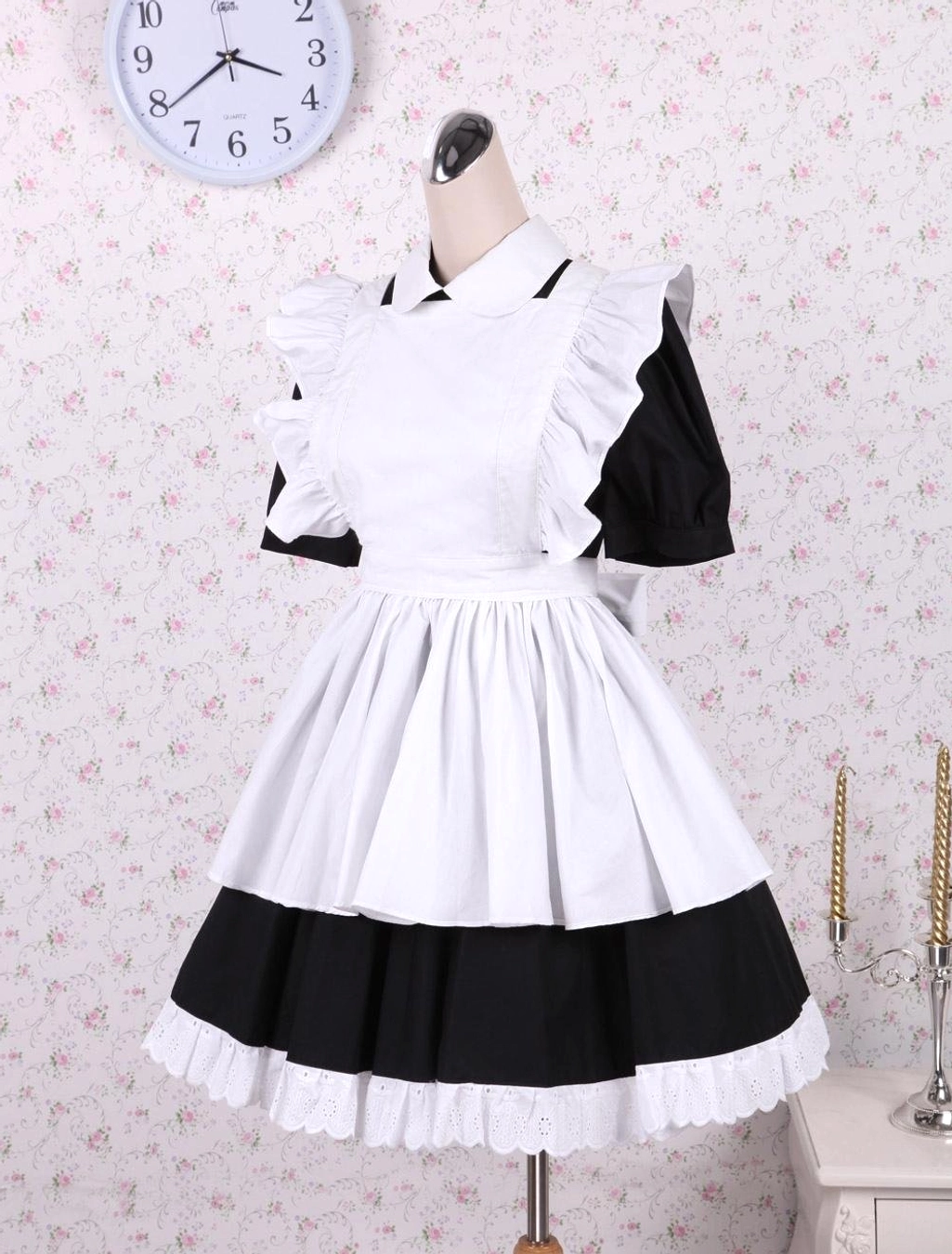 Side three-quarter mannequin view maid lolita dress with shoulder apron flared skirt black-white color block design