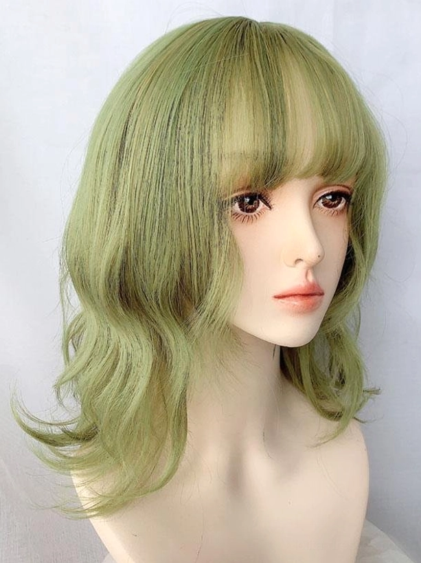 Harajuku lolita short wig in matcha green with air bangs and wavy texture, front three-quarter studio display on white background
