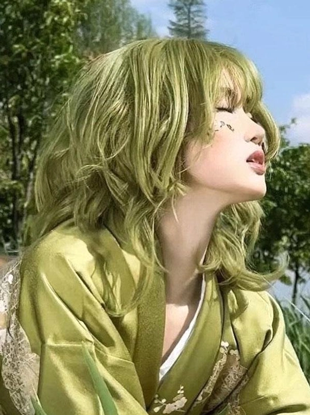 Sweet lolita short wig in matcha green with wavy texture, right three-quarter angle view with matching green kimono coordination