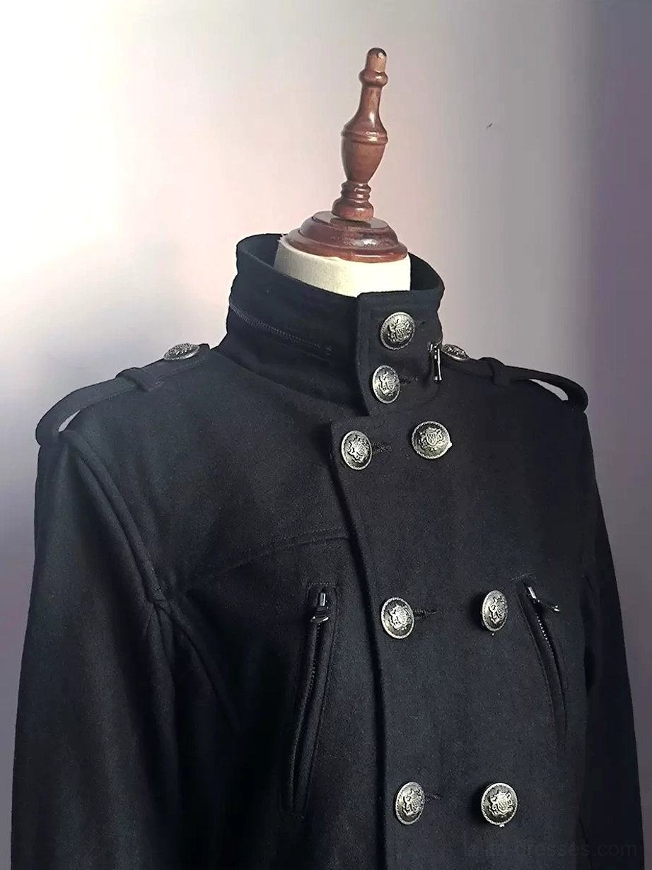 Close-up detail of military coat collar and shoulder epaulets on mannequin, embossed round metal buttons, and decorative zipper pockets showcasing craftsmanship