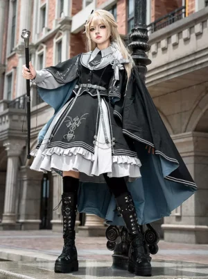 Military Lolita dress set front three-quarter view black polyester dress with silver cross embroidery feather shoulder accent blue-lined cape blonde model vintage European street