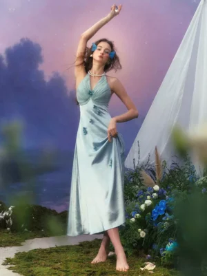 Mint blue satin halter backless fairy dress with 3D floral embellishments, full-body side-front view on model with blue hair accessories