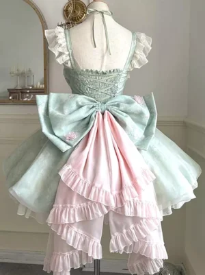 rear view of mint green fairy lolita dress showing layered ruffled train halter neck strap and color-block bow detail
