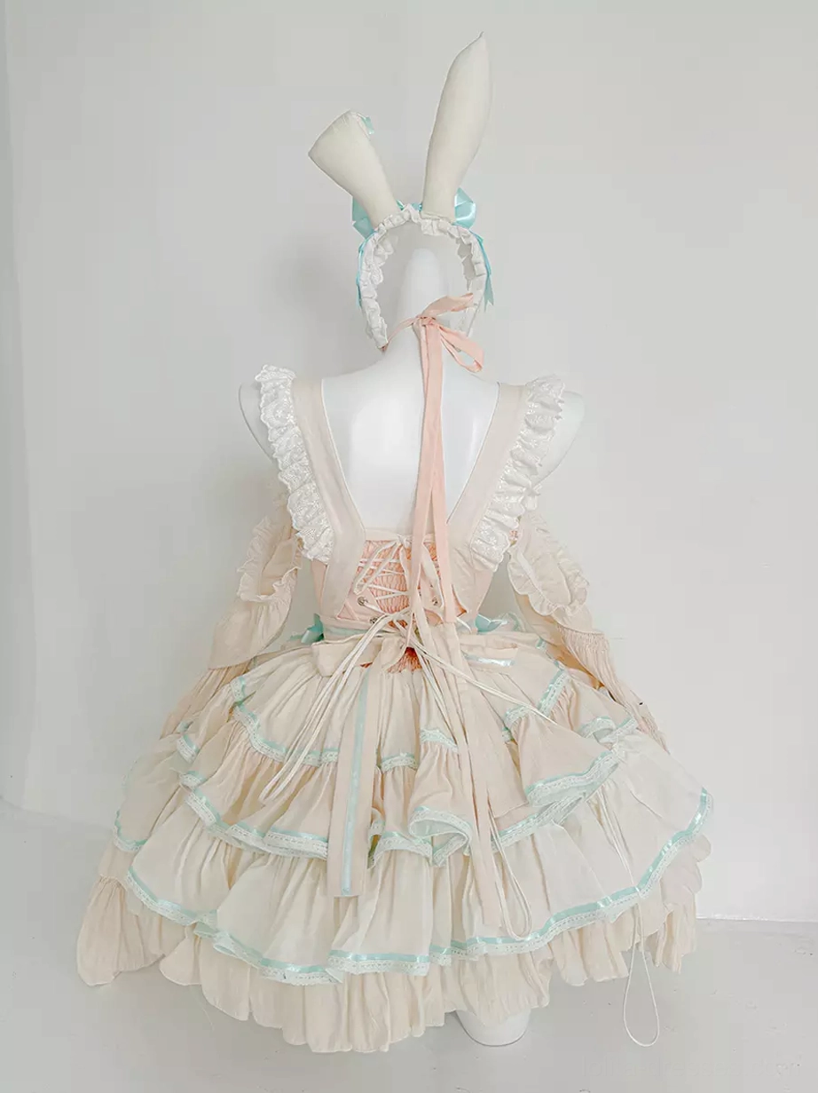 Detail view of mint green lolita dress showing ruffled trim, bow embellishments, and quality polyester fabric construction in sweet lolita style