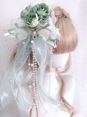 Mint green elegant lolita headband featuring sheer ribbons, green artificial flowers and lustrous pearl chains, displayed on mannequin modeling classic lolita aesthetic with detailed lace trim embellishments